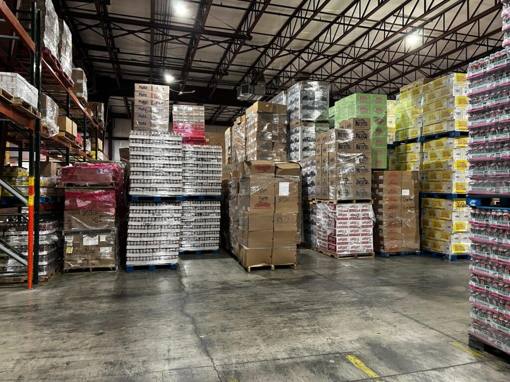 Thomas Trading warehouse with pallets of discounted food and household items